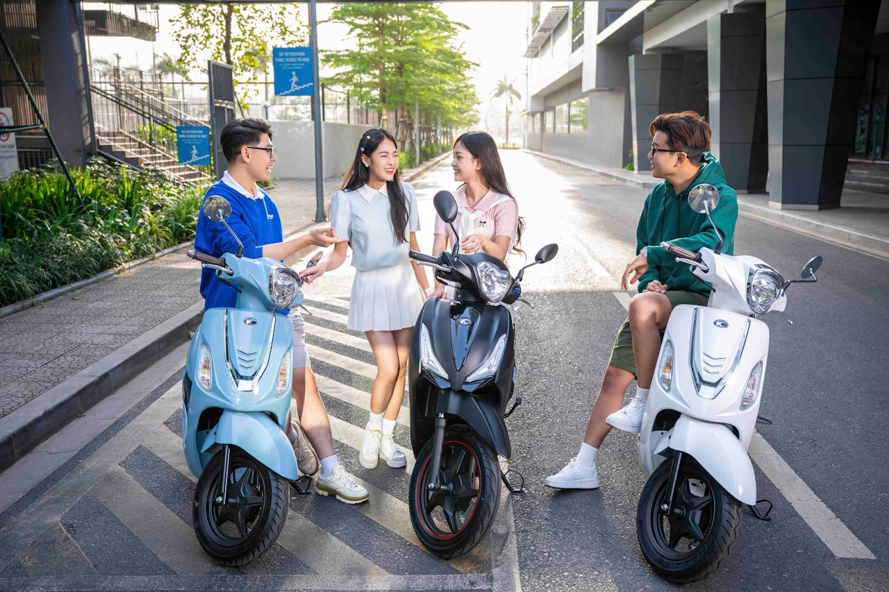 Group of friends on scooters sharing a fun moment on a sunny day in Vietnam.